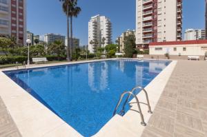 a swimming pool in the middle of a building at AG Aquarium in Playa de Gandia