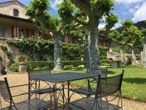 een tafel en stoelen voor een gebouw bij Clos de Mont July, chambres avec vue et terrasse dans demeure historique in Ceyzériat