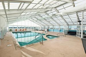 a large indoor swimming pool in a building at Ocean Sands Resort, Oceanfront, Virginia Beach by Vacatia in Virginia Beach
