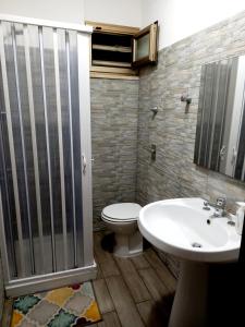 a bathroom with a shower and a toilet and a sink at Liberty House in Marsala