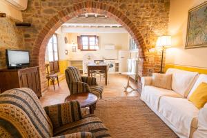 an archway in a living room with a couch and chairs at Podere San Selvatico in Città della Pieve