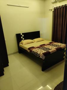 a bedroom with a bed in a room at Aikya in Mangalore