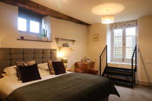 a bedroom with a large bed and a window at The Castle Hotel in Bishops Castle