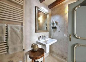 a bathroom with a sink and a mirror at Apt Teatro in Venice +59 photos