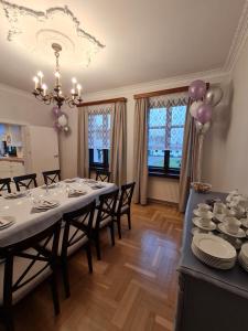 a dining room with a table with plates and balloons at Wrzosowe Siedlisko in Czosnów