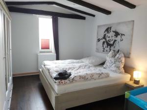 1 dormitorio con 1 cama con una pintura en la pared en Gutshofwohnung - Speicher-Loft, en Klein Upahl