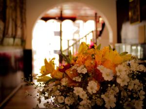 a bouquet of flowers in a vase on a table at Hotel Santa Maria in Cusco