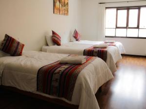 Cama ou camas em um quarto em Hotel Santa Maria