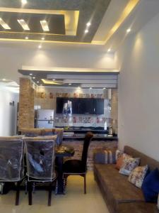 a living room with a couch and a table at قرية رمسيس الكيلو45 الساحل الشمالي in Borg El Arab +34 photos