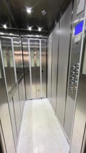 a walk in shower with metal walls and doors at Apartment Hospodárska in Trnava