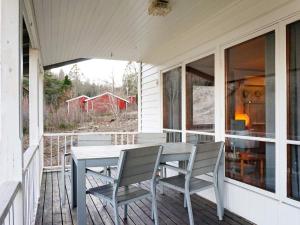 a porch with a table and chairs on it at 6 person holiday home in BRASTAD in Brastad