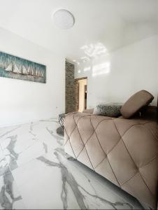 a bedroom with a bed with a marble floor at Luxury Apartment ASIA 2 Rijeka in Rijeka