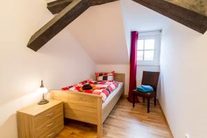 a bedroom with a bed and a desk and a window at Gutshof-Loft Sonnenschein in Klein Upahl