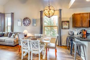 a kitchen and living room with a table and chairs at Summit Point Place in Granby
