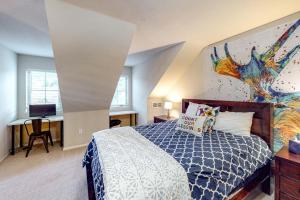 a bedroom with a bed with a blue and white comforter at Summit Point Place in Granby