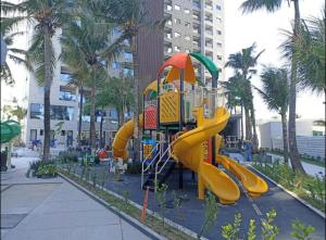 a playground with a slide in a park at Salinas Premium Resort in Salinópolis