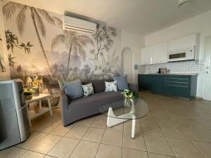 a living room with a couch and a table at Casa Caribe Appartamento Attico in Bayahibe