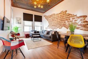 a living room with a brick wall and a table and chairs at Origine Rentals Galata Tower in Istanbul