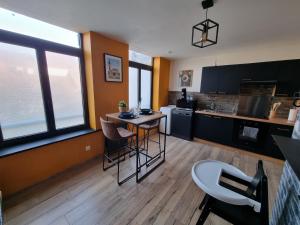 a kitchen with a table and some chairs in it at comme un air de chez soi in Calais +12 photos