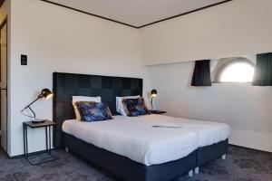 Säng eller sängar i ett rum på Hotel Pauw