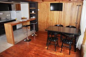 eine Küche mit einem Tisch und Stühlen im Zimmer in der Unterkunft Monasterio Hotel Boutique in San Carlos de Bariloche