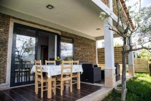 a dining room with a table and chairs on a patio at Casas do Paço - Casas de Férias in Cabeceiras de Basto