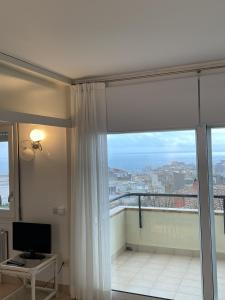 Televízia a/alebo spoločenská miestnosť v ubytovaní L'Escala Vista Mar