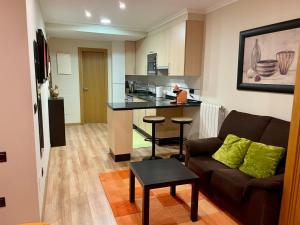 a living room with a couch and a kitchen at Ronda De Don Bosco52 By Vigovacaciones in Vigo