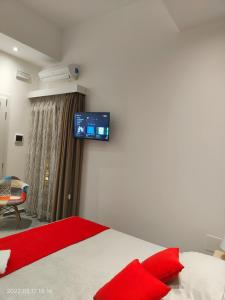 a bedroom with a bed and a tv on the wall at Bed Nonnonino in Porto Cesareo