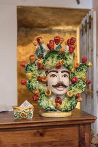 a statue of a man with food on his head at Le Teste di Moro al Duomo in Agrigento