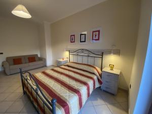 a bedroom with a bed and a couch at The Reef Apartment in Sorrento