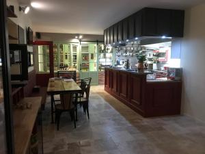 a kitchen and dining room with a table and chairs at L'Atelier 1 in Corcelles-les-Arts