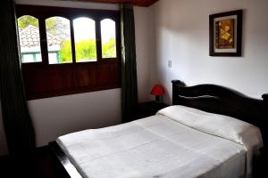 Łóżko lub łóżka w pokoju w obiekcie Hotel Itzamana