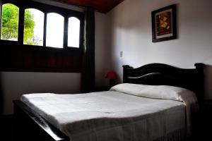 Łóżko lub łóżka w pokoju w obiekcie Hotel Itzamana