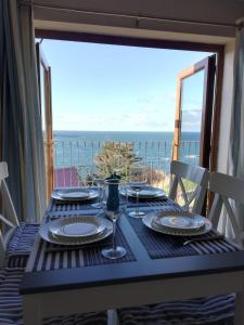 a dining table with a view of the ocean at Sunnyside House in Gardenstown