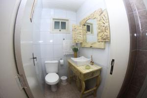 a small bathroom with a toilet and a sink at Rosa dos Ventos - CASA in Urubici +22 photos