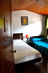 Łóżko lub łóżka w pokoju w obiekcie Hotel Itzamana