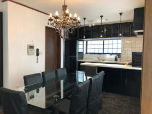 a dining room with a glass table and chairs at BIWAKO RESORT Second House in Omihachiman