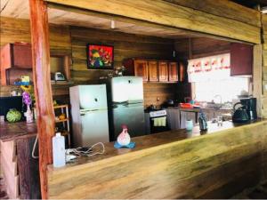 a kitchen with two refrigerators and a counter top at Sunset Inn Arenal B&B in El Castillo de La Fortuna