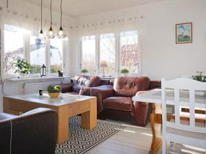 a living room with a couch and a table at Holiday home GAMLEBY V in Gamleby