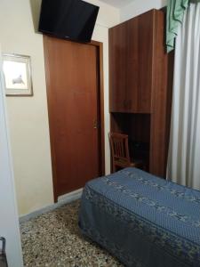 a bedroom with a bed and a wooden door at Atlantide Hotel in Venice