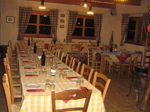a large dining room with a long table and chairs at Agriturismo Val Codera in Verceia
