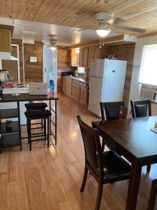 a kitchen with a table and chairs and a refrigerator at Home in the Heart of W.V. Adventure Country! in Mount Hope