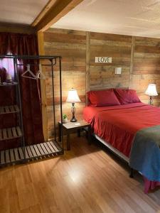 a bedroom with a bed with a red comforter at Home in the Heart of W.V. Adventure Country! in Mount Hope