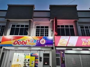 a building with signs on the front of it at TAMU HOMESTAY in Kuala Terengganu