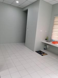 a room with a white tiled floor and a window at TAMU HOMESTAY in Kuala Terengganu