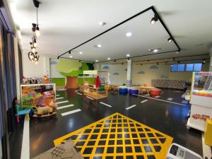 a room with a toy store with a yellow line on the floor at Slow Wow Hot Spring Hotel in Jiaoxi