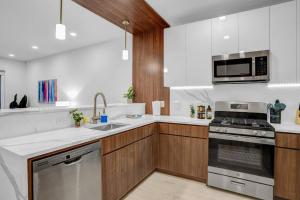 a kitchen with wooden cabinets and a stove top oven at NEW Graceful 1BR Near EWR Free Parking 18 Min NYC in Newark