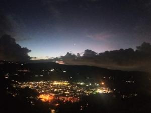 a view of a city lit up at night at Cabaña del Colibri, la Guacamaya y la Mariposa in Sopo