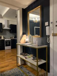 a kitchen with black walls and a mirror and a table at Glamours stylish Victorian apartment near city centre in Edinburgh